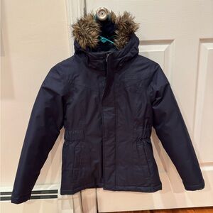 The North Face Girls Dark Blue Arctic Down Parker Jacket with Faux Fur Hood.